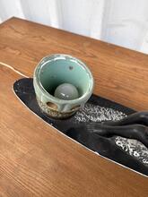 Beeld man in kano lamp  antiek